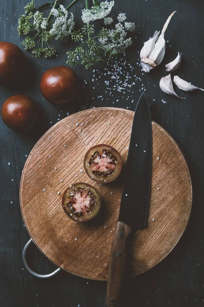 Top View Black Prince Tomatoes Wooden Cutting Board Knife Garlic Стоковое Изображение